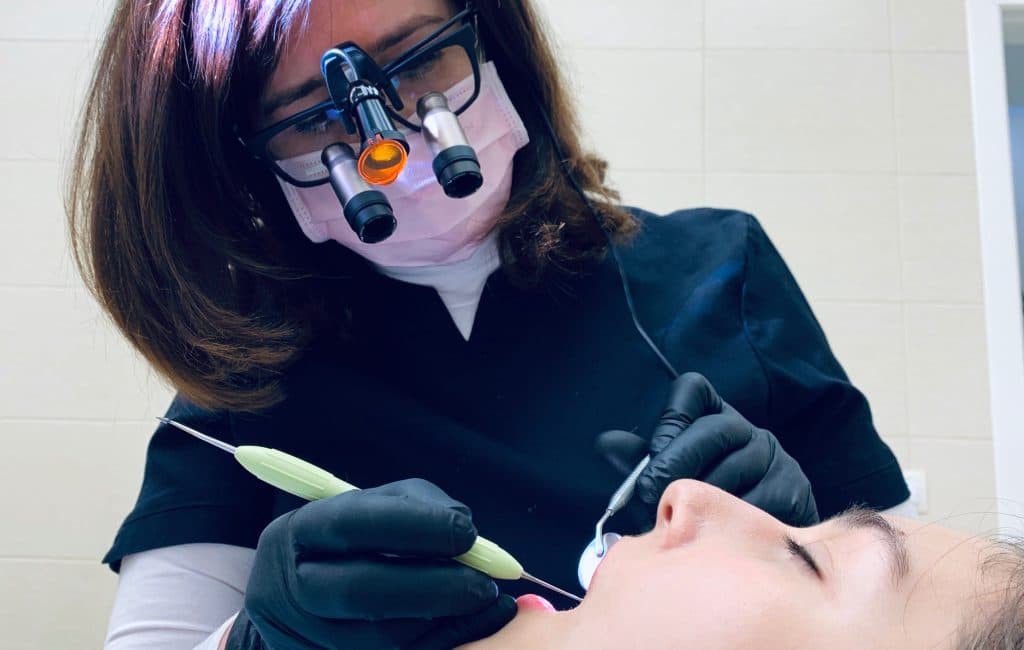 Dentiste qui soigne une patiente en Suisse